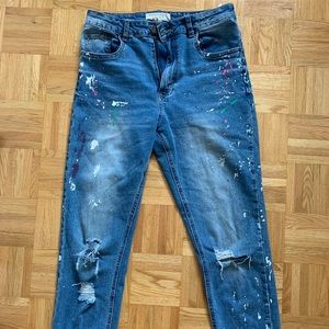 Ripped mom jeans with multicolor paint splatters